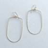 Joy Handcrafted, elongated geometric earrings in 14k gold fill or sterling silver, featuring a hammered bottom for added texture.