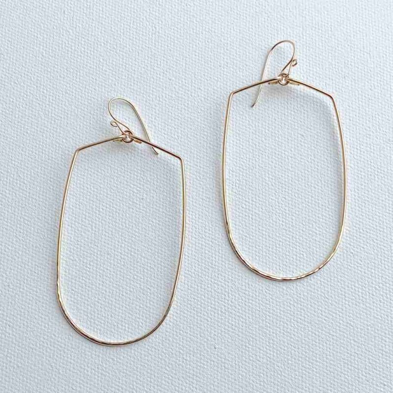 Joy Handcrafted, elongated geometric earrings in 14k gold fill or sterling silver, featuring a hammered bottom for added texture.