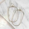 Joy Handcrafted, elongated geometric earrings in 14k gold fill or sterling silver, featuring a hammered bottom for added texture.