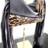Dominique black leather bag with animal print and long fringe.