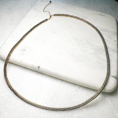 Jovie Necklace crafted with hematite beads and 14K gold-filled extension, adjustable to 23 inches with lobster clasp closure.