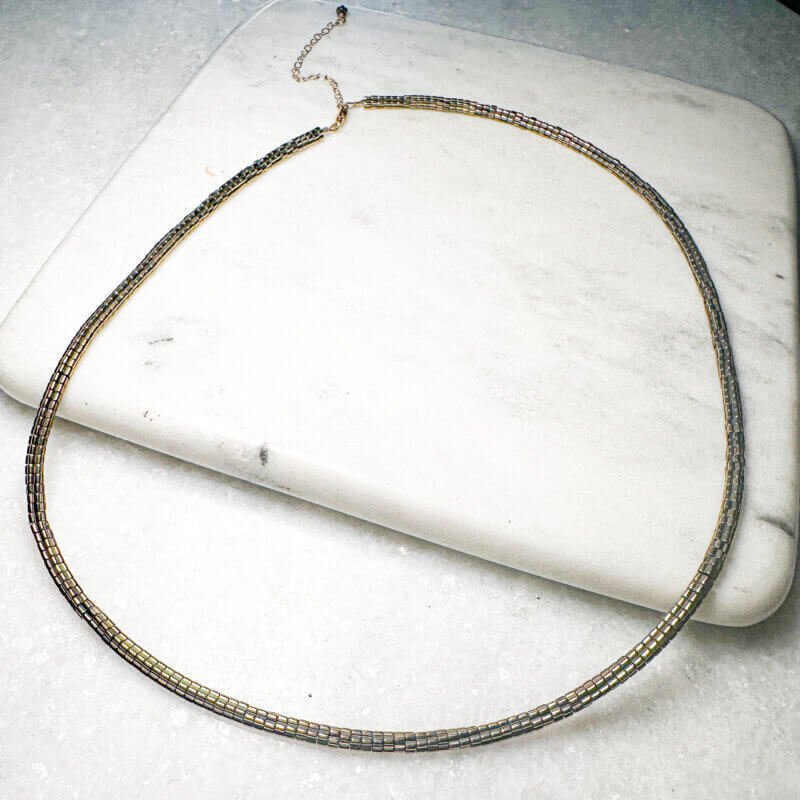 Jovie Necklace crafted with hematite beads and 14K gold-filled extension, adjustable to 23 inches with lobster clasp closure.