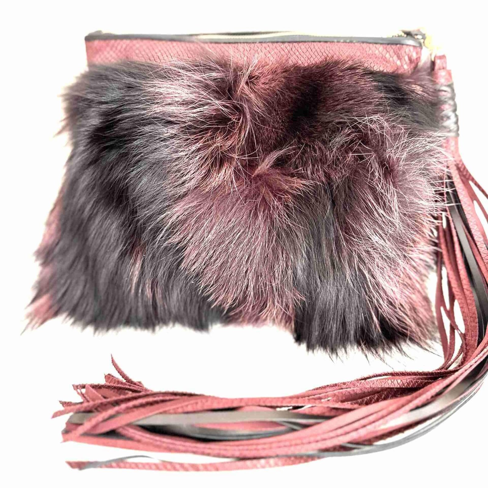 Mercer Fox Fur Clutch Bag with black and magenta fur, brass zipper closure, and magenta lining, displayed on a modern surface.