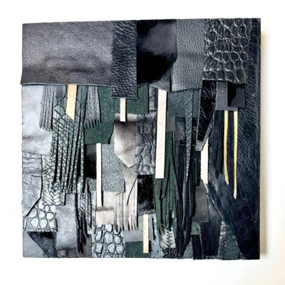 Abstract wall art made from black and textured leather scraps on wood