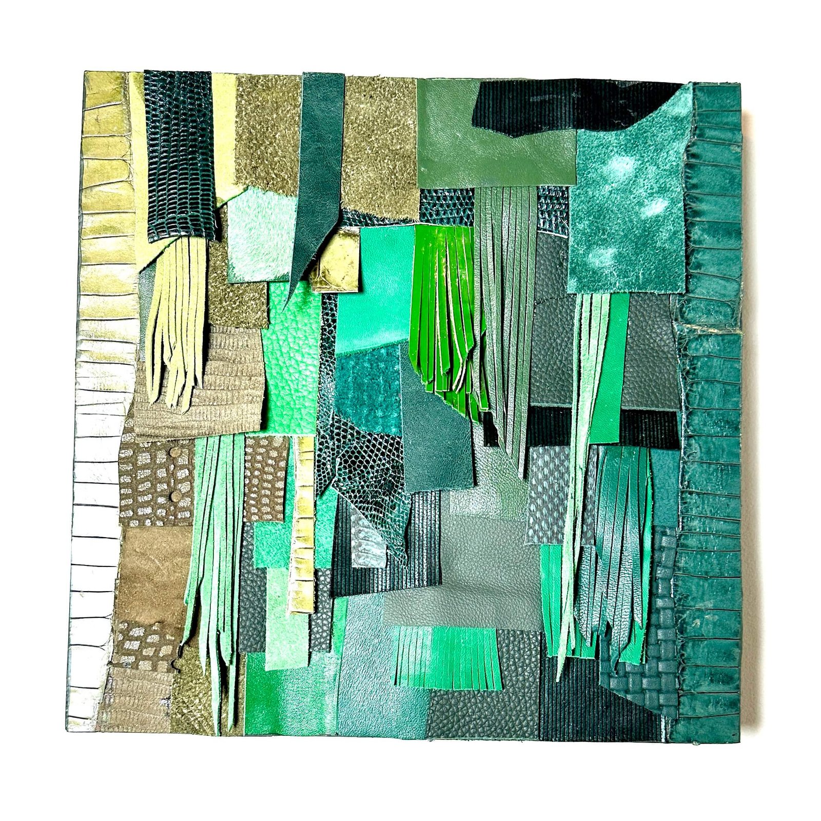 Handmade green leather collage art on wood with exotic textures