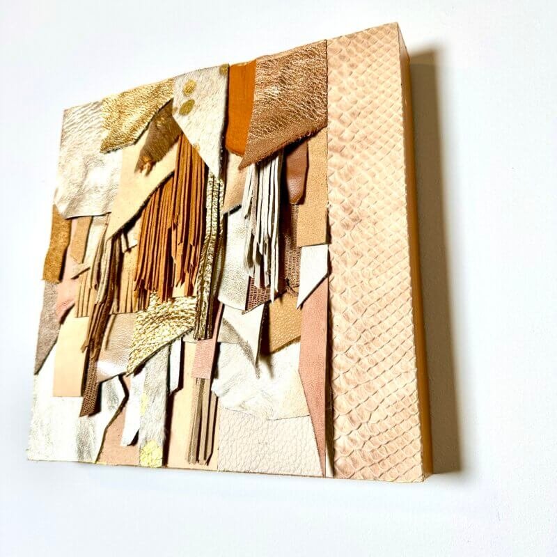 Abstract leather wall art in neutral and gold tones on wood base