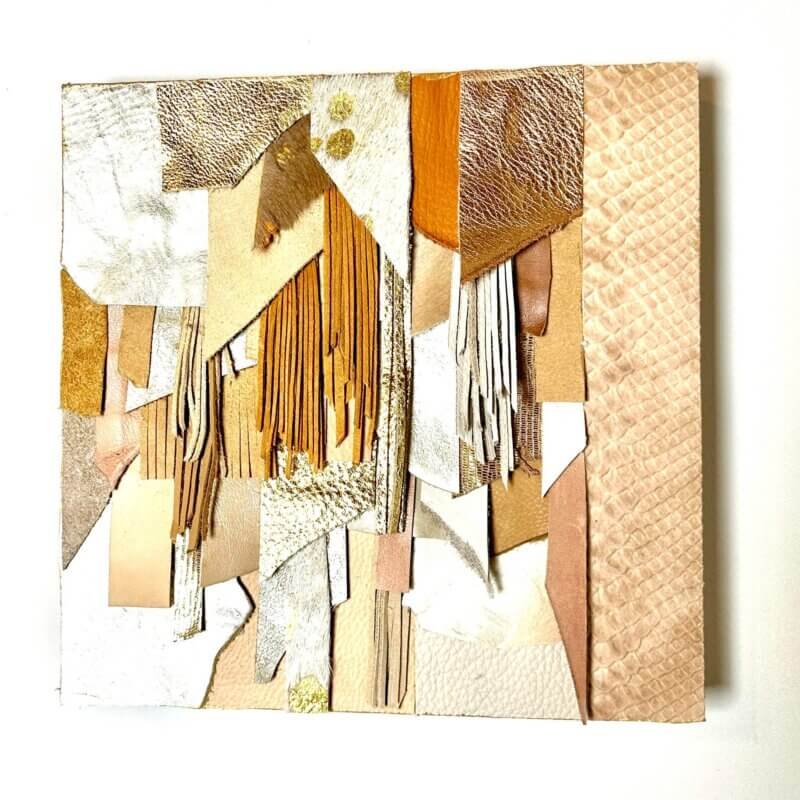 Abstract leather wall art in neutral and gold tones on wood base